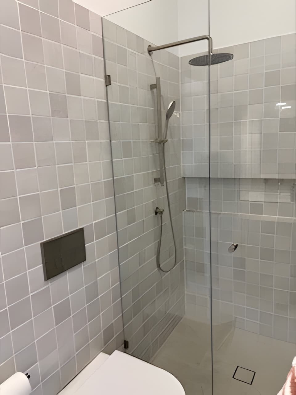 Modern bathroom with large format grey tiles