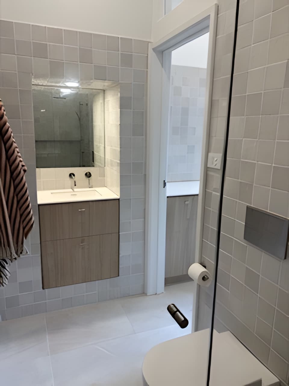 Contemporary bathroom with feature tile wall